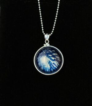 A necklace with a picture of a blue fire.