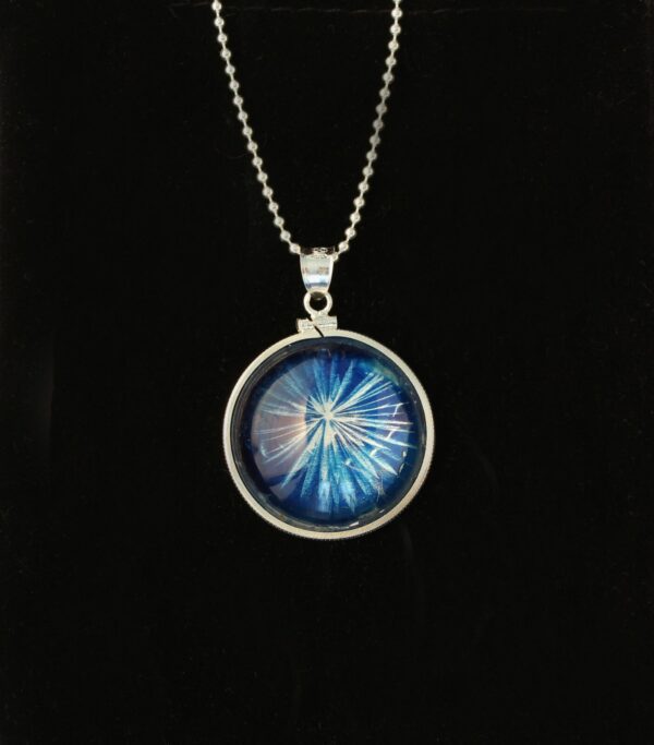 A necklace with a picture of a blue star in it.