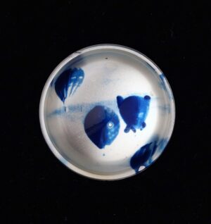 A bowl with blue paint on it