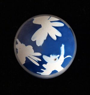 A blue and white ball with flowers on it.