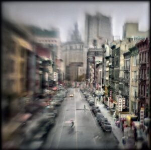 A blurry picture of a city street with cars driving down it.