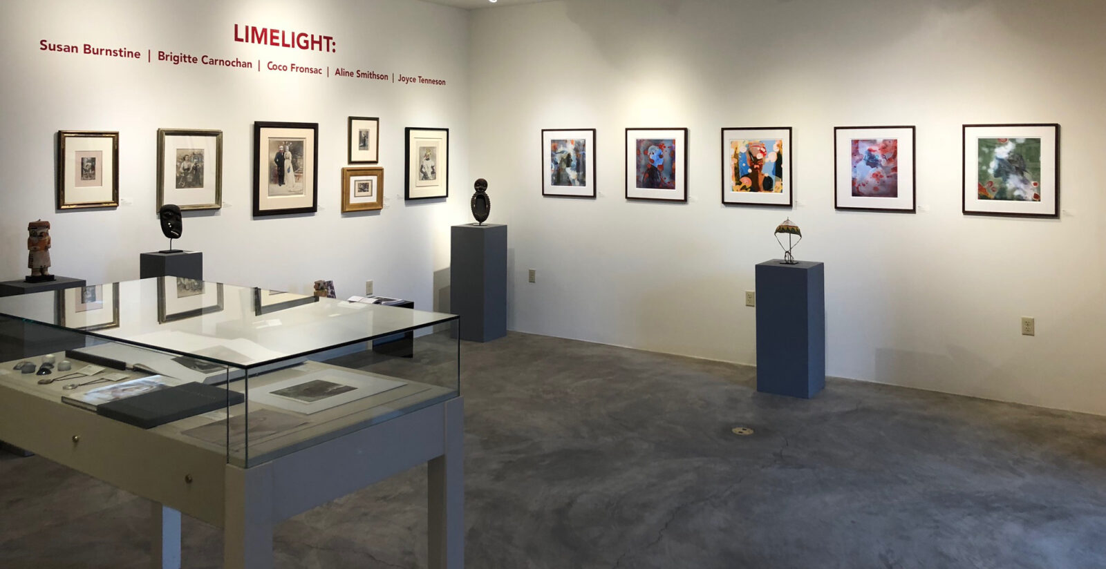Art gallery showcasing framed artworks and sculptures.