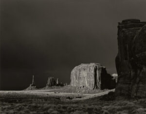 A black and white photo of the monument valley