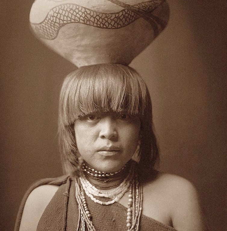 Person with a decorated pot on their head.