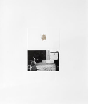 A black and white photo of a room with a clock on the wall.