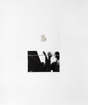 A person is reaching up to catch an object.