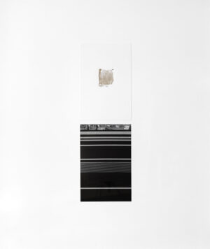 A black oven with white wall behind it