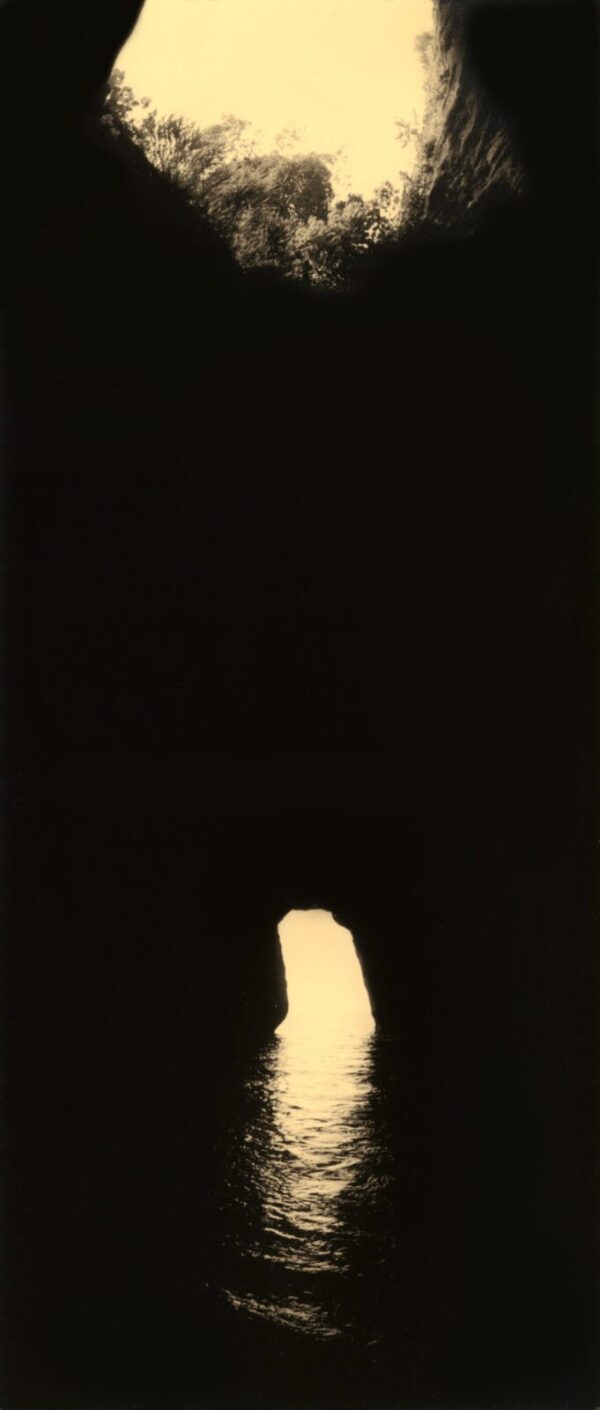 A lit candle in the dark with black background