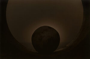 A black hole in the sky with a sun behind it.