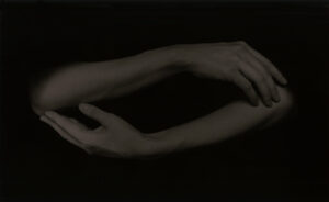 A black and white photo of two hands