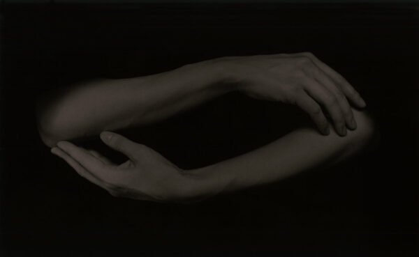 A black and white photo of two hands