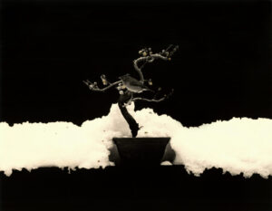 A black and white photo of smoke coming out from the ground.
