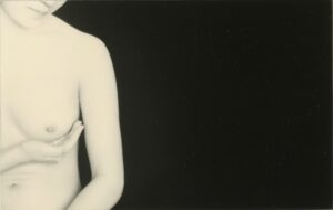 A woman with her hand on her chest.