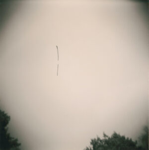 A long strip of plane flying in the sky.