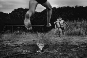 A man jumping in the air over water.