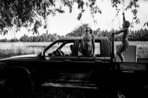 A man sitting in the back of an old truck.