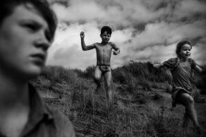 A man in underwear standing on top of a hill.