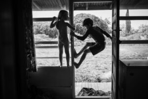 A boy and girl are jumping in the air.