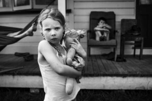 A girl holding a cat in her arms.