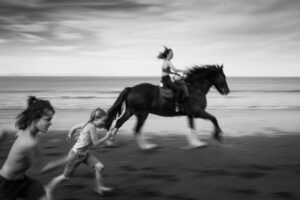 A woman riding on the back of a horse.