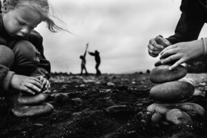 A black and white photo of people sitting on rocks