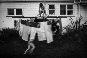 A person standing on top of a clothes line.