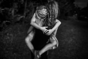 A woman is tied up and hugging another woman.