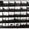 A black and white photo of a person jumping in the air.