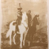 A man and woman on horseback in an old photo.