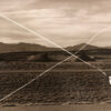 A person flying a kite in the middle of nowhere.