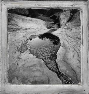 A black and white photo of water in the ground.