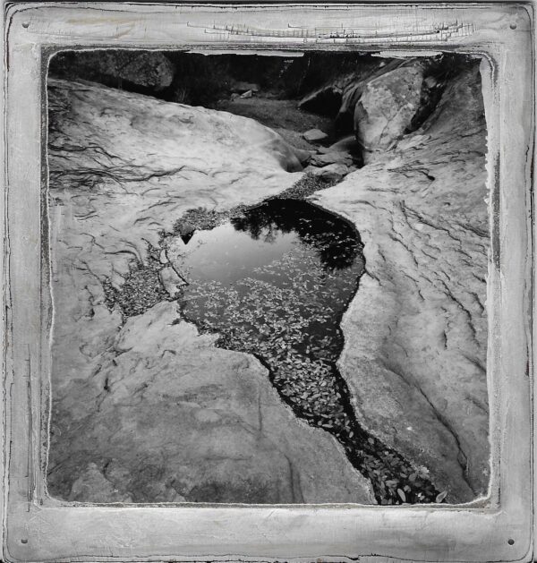 A black and white photo of water in the ground.