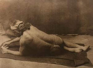 A man laying on the ground with his back turned to the side.