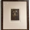 A framed picture of a person holding something