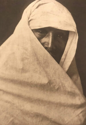 A man with a white cloth around his head.