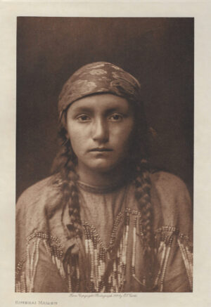 A woman with braids and a head scarf.