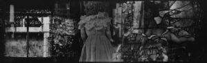 A black and white photo of a woman in a dress
