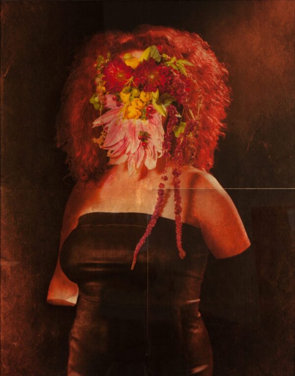 A woman with red hair and flowers in her head.