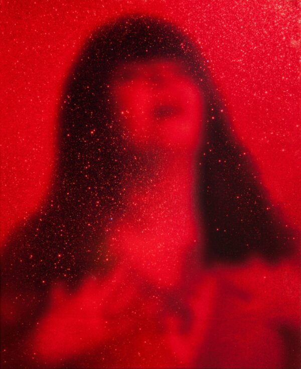A blurry image of a woman in red.