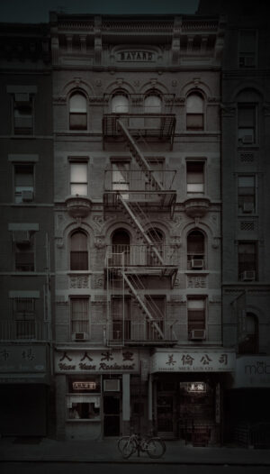 A building with fire escapes on the side of it.