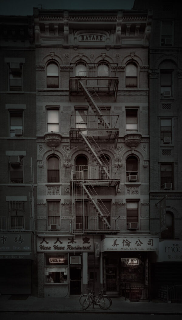 A building with fire escapes on the side of it.