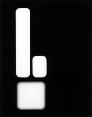 A black and white photo of an object in the dark.
