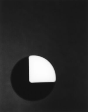 A black and white photo of an object in the dark.