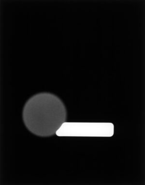 A black and white photo of the moon with a beam.