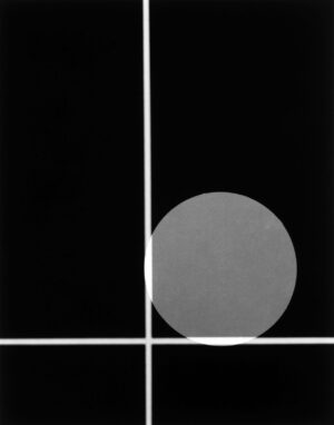 A black and white photo of a ball in the middle of a grid.