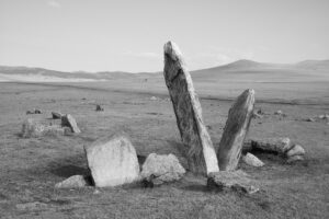 A black and white photo of some rocks in the desert.