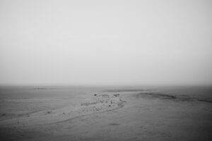 A black and white photo of an empty beach