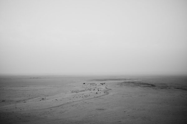 A black and white photo of an empty beach