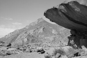 A black and white photo of mountains in the distance.