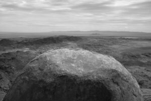 A black and white photo of an object in the middle of nowhere.